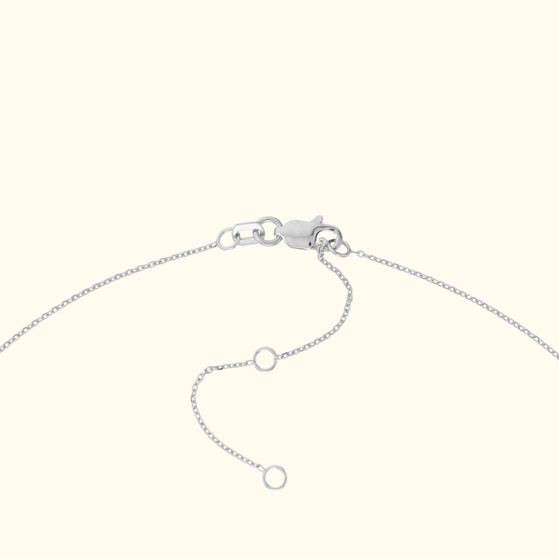 Silver bracelet clasp with adjustable chain links laid against a light background.