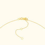 Delicate gold chain necklace clasp with adjustable links.