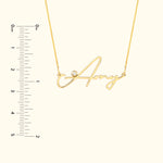 Gold necklace with the name "Amy" in cursive, featuring a small diamond accent.