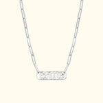 Silver chain necklace featuring an intricately designed pendant.