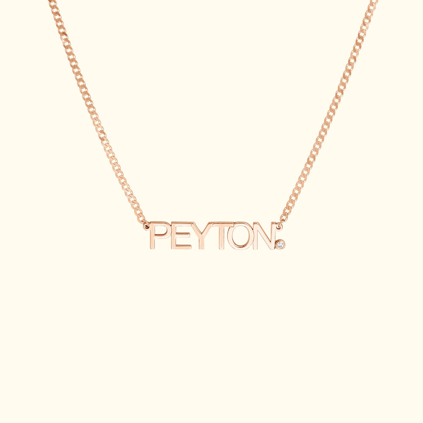 Rose gold necklace with the name "PEYTON" in bold letters and a small diamond accent.