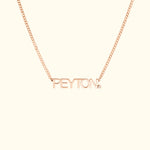Rose gold necklace with the name "PEYTON" in bold letters and a small diamond accent.