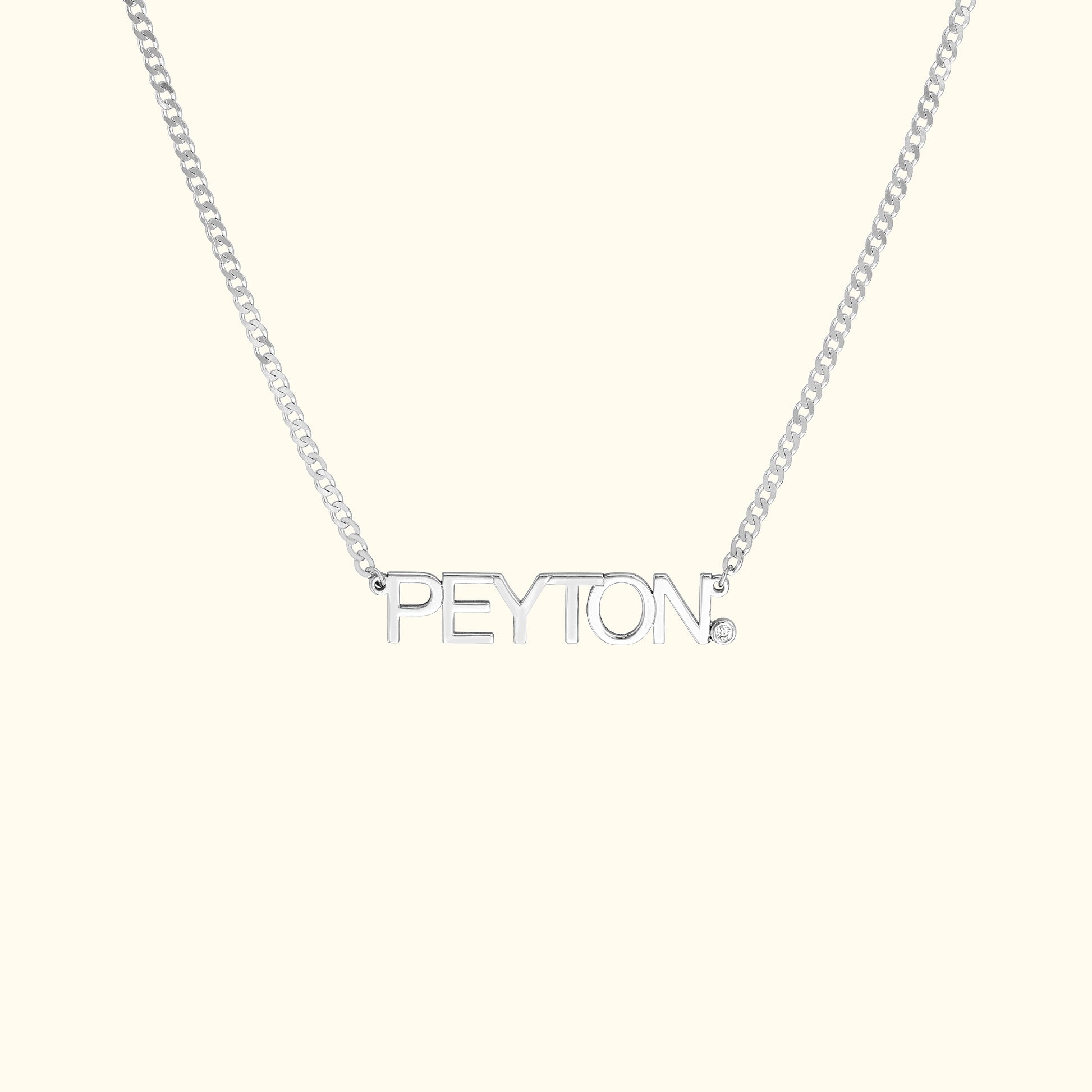 Silver name necklace featuring the name "PEYTON" with a small diamond accent.