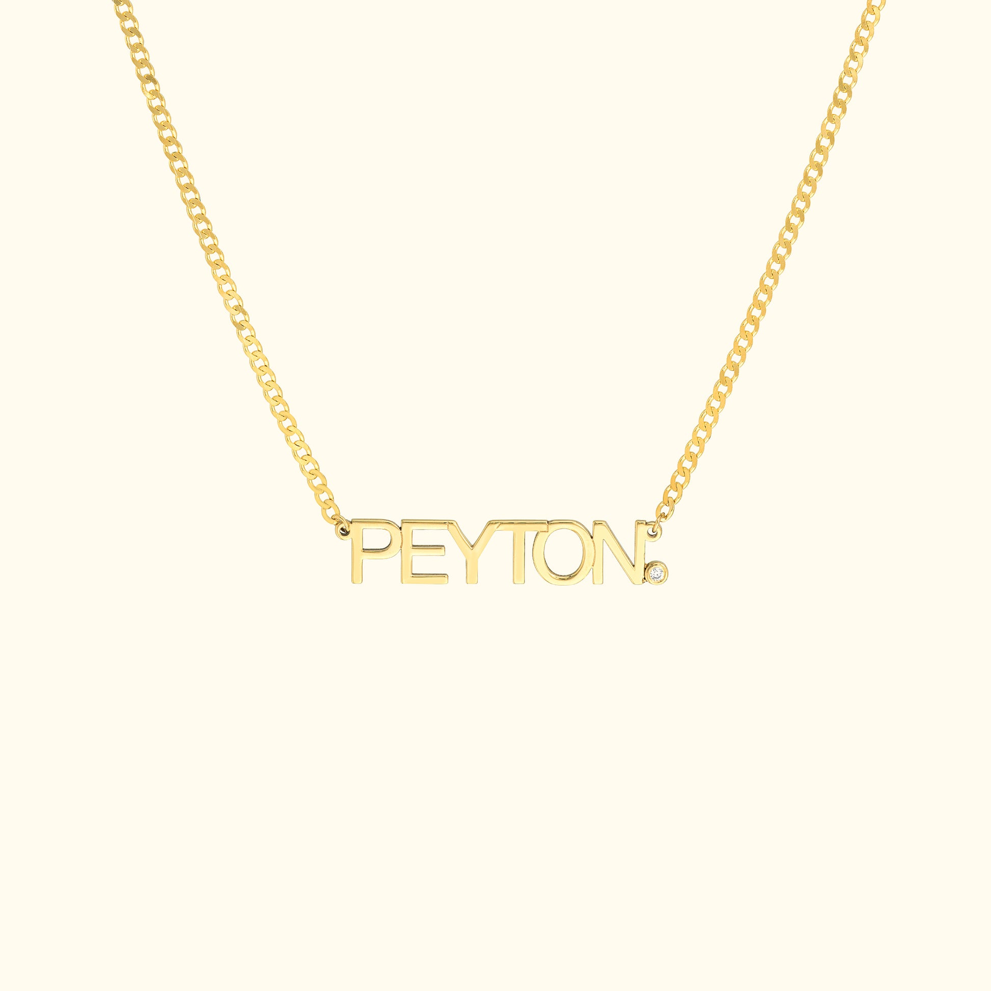 Gold necklace featuring the name "PEYTON" in bold letters.