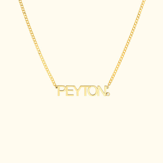 Gold necklace featuring the name "PEYTON" in bold letters.