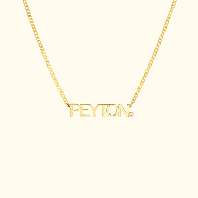 Gold necklace featuring the name "PEYTON" in bold letters.