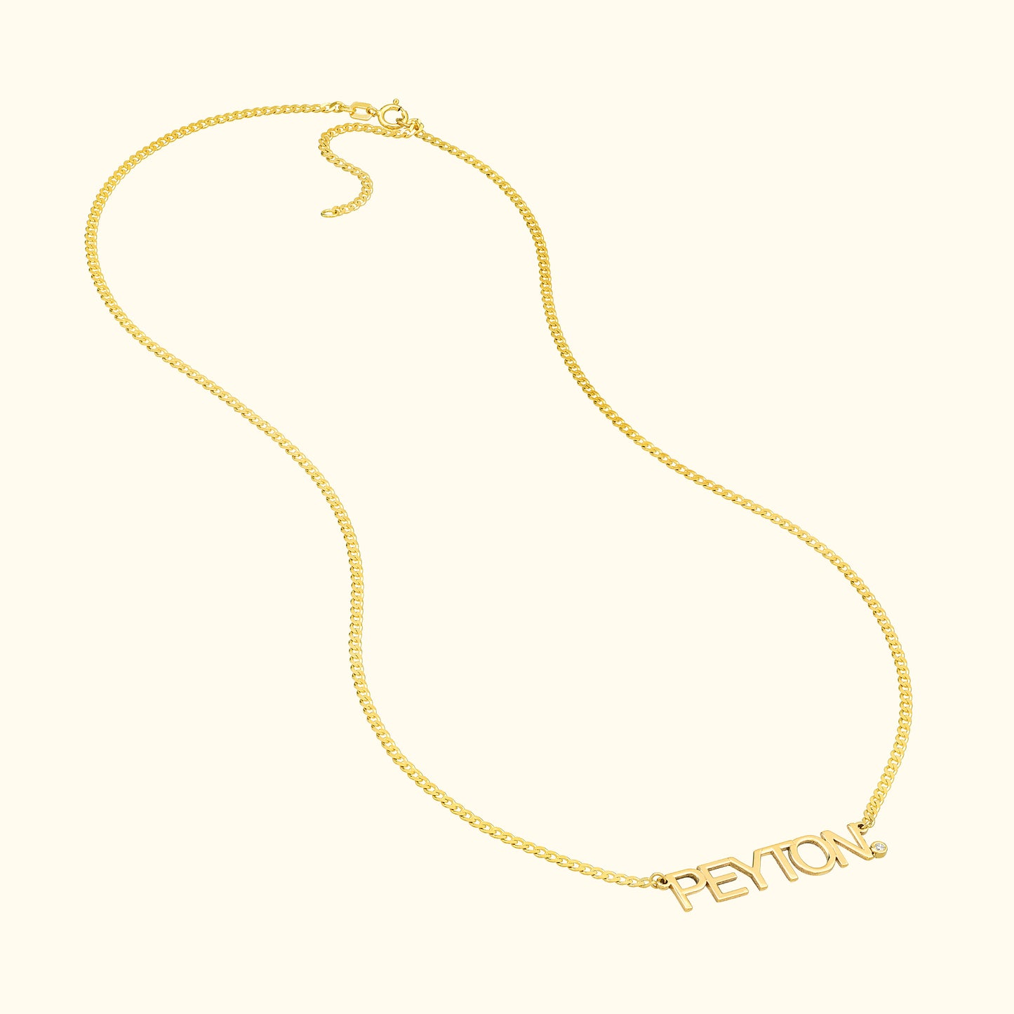 Gold name necklace with the word "PEYTON" in cursive lettering.