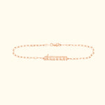 Personalized rose gold name bracelet with a chain link design.