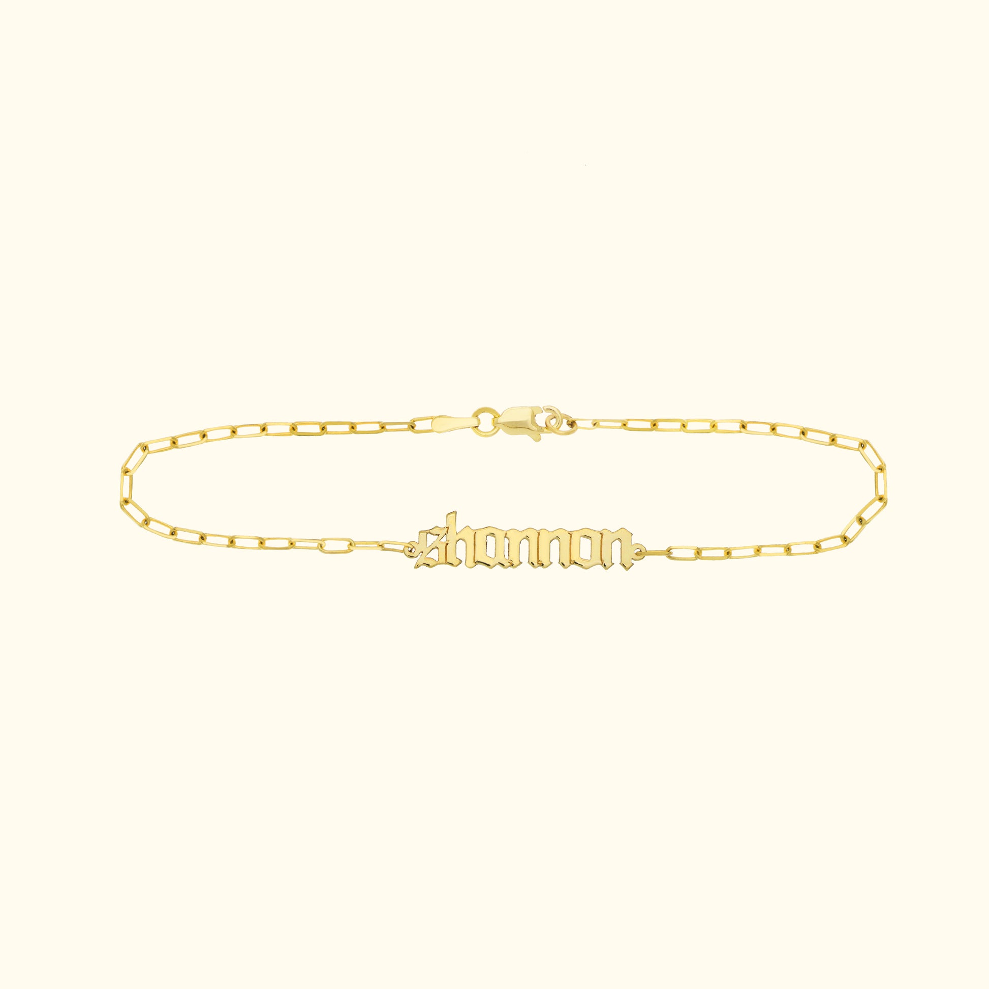 Gold nameplate bracelet with the name "shannon" in a stylish cursive font.