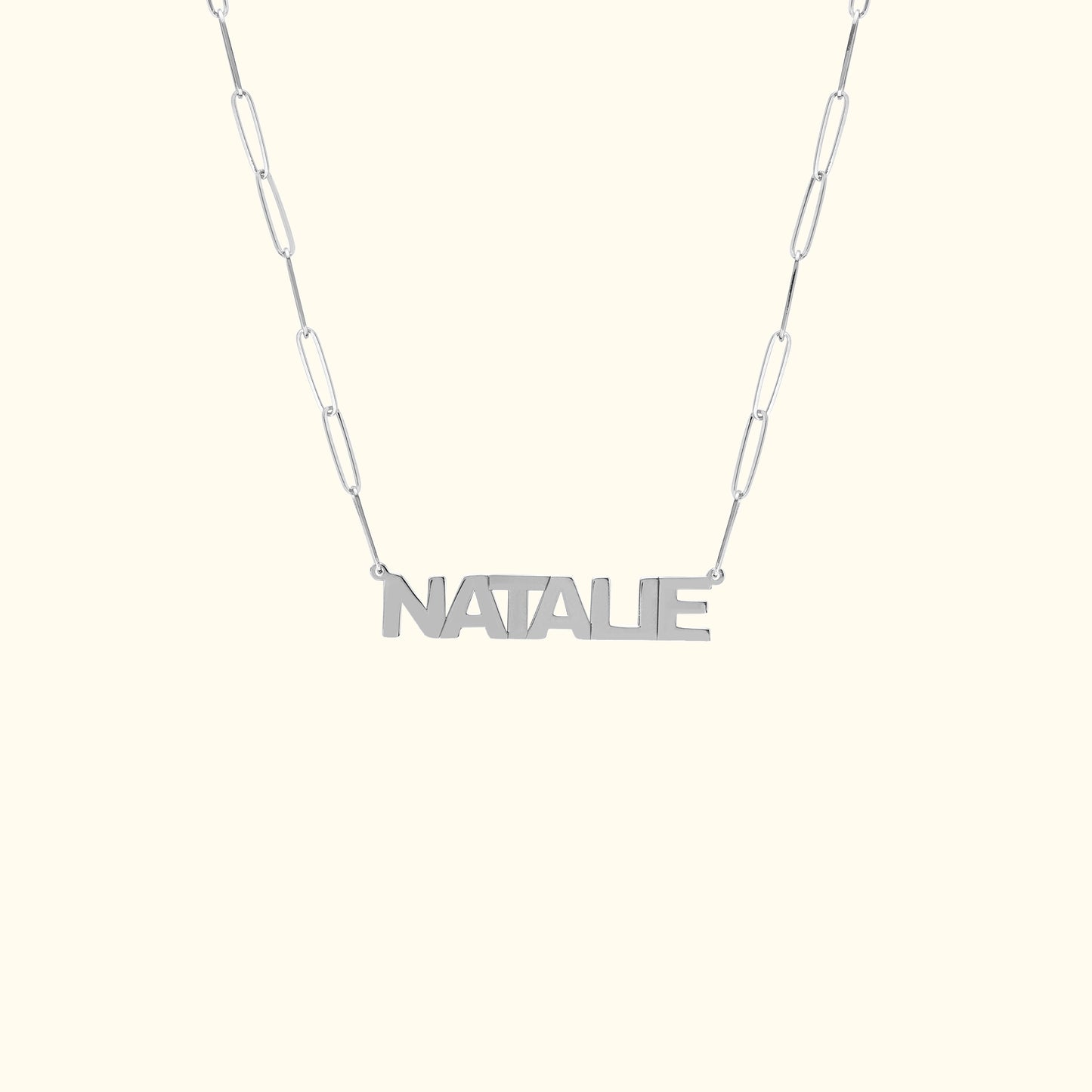 Personalized silver necklace with the name "NATALIE" on a linked chain.