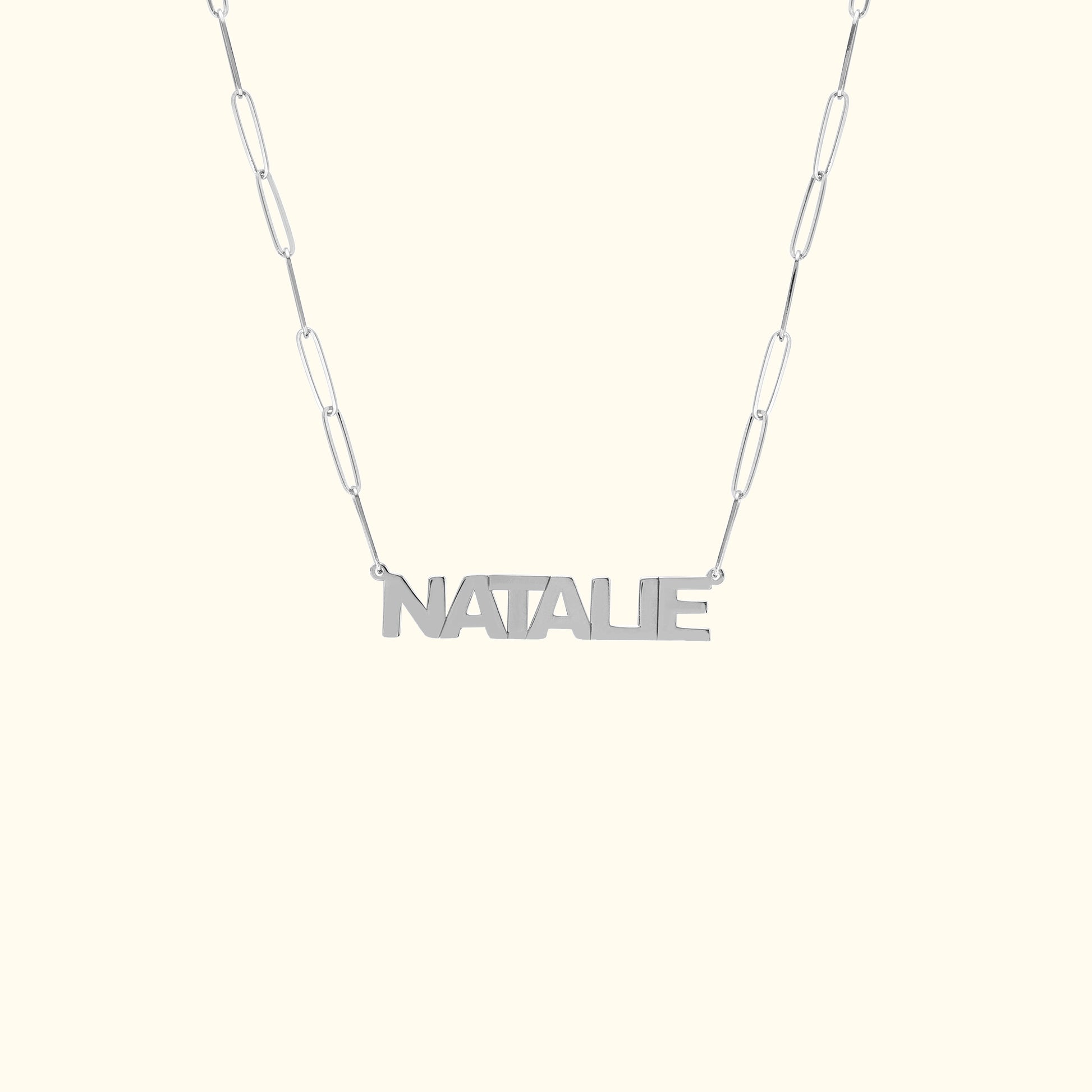 Personalized silver necklace with the name "NATALIE" on a linked chain.