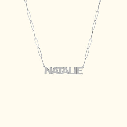 Personalized silver necklace with the name "NATALIE" on a linked chain.