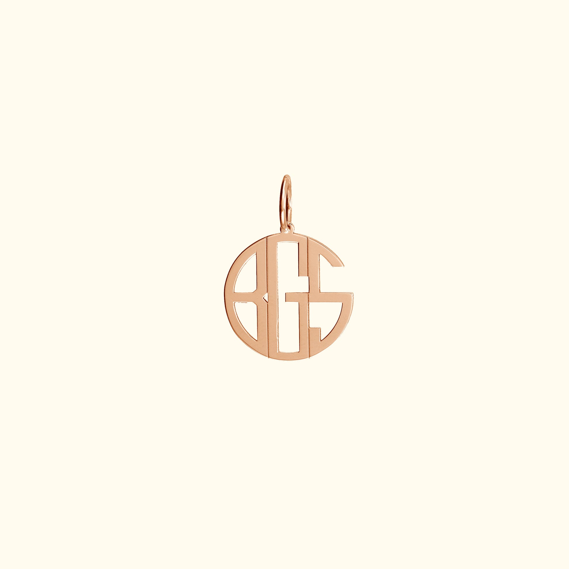 Rose gold monogram pendant in a circular design.