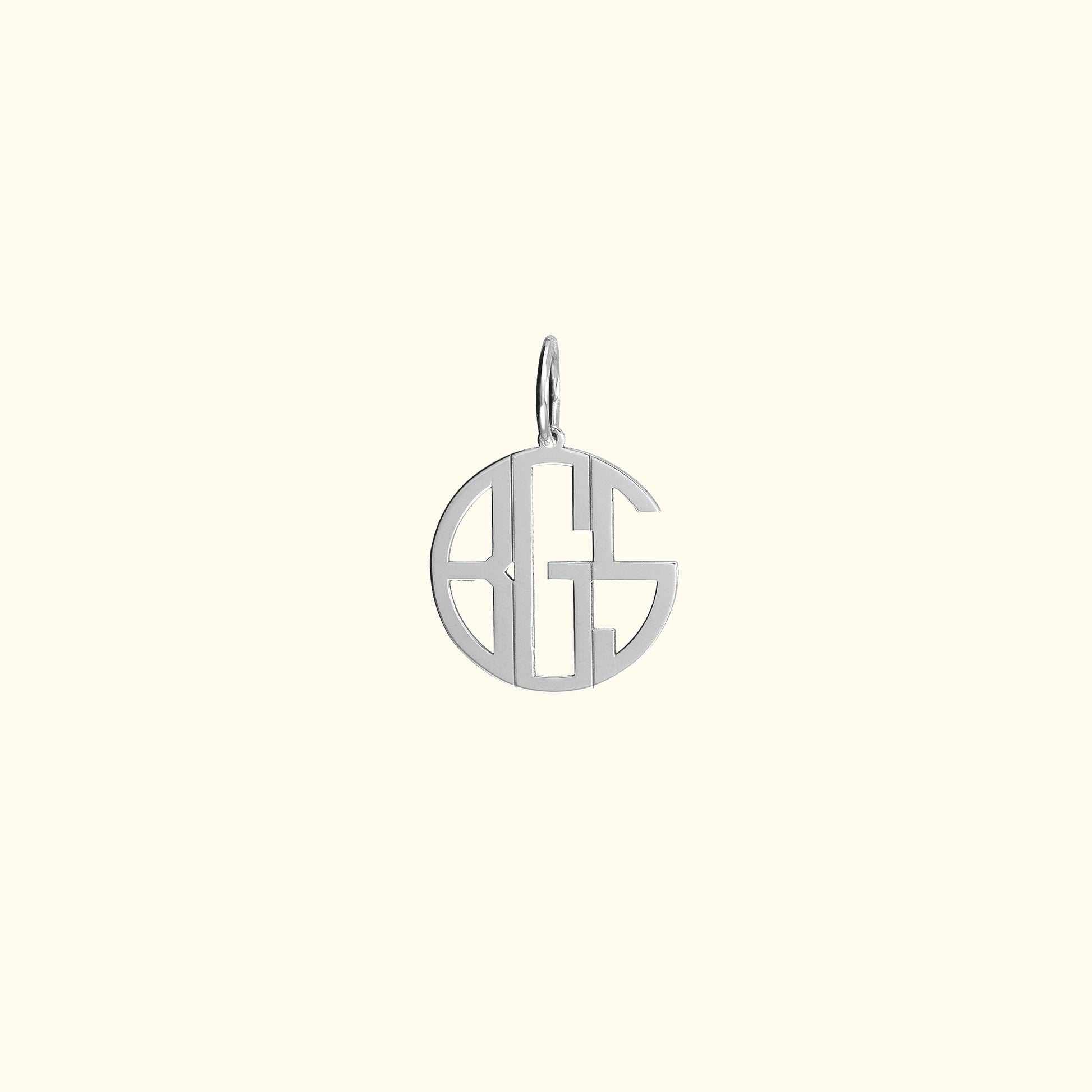 Silver monogram charm with circular design and open lettering.