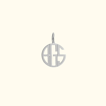 Silver monogram charm with circular design and open lettering.