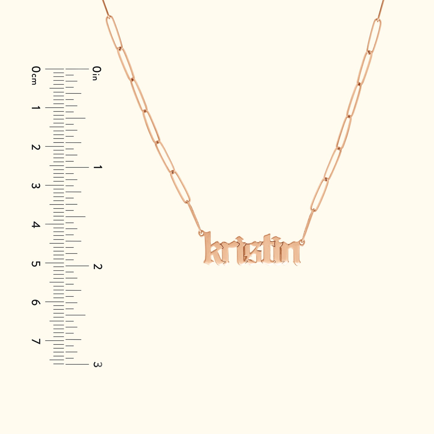 Rose gold necklace featuring the name "kristin" in a decorative font with a ruler for size reference.