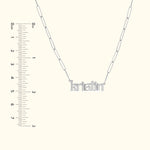 Silver necklace with the name "kristin" in decorative lettering. Ruler for scale included.