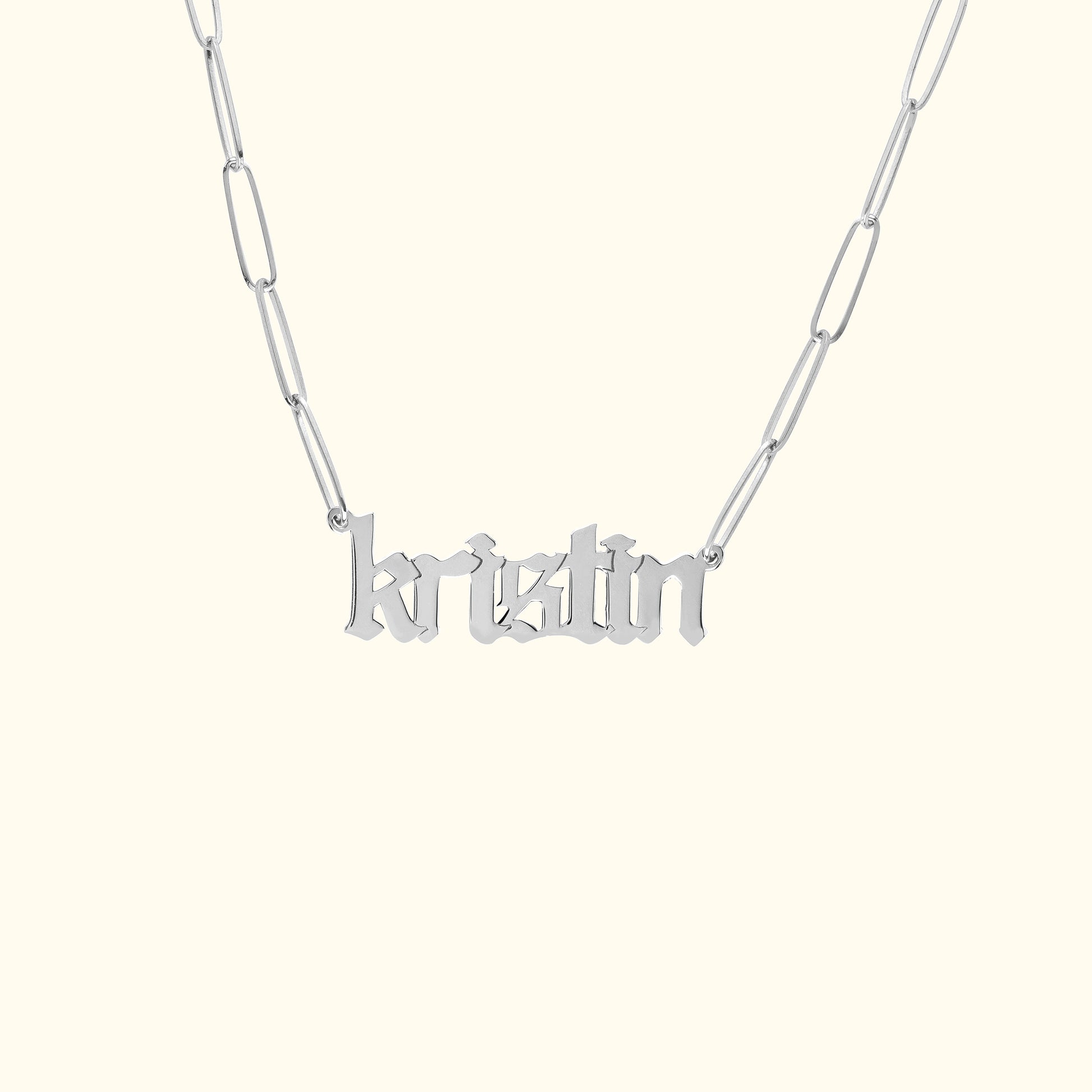 Silver name necklace with the word "kristin" in a stylish font.