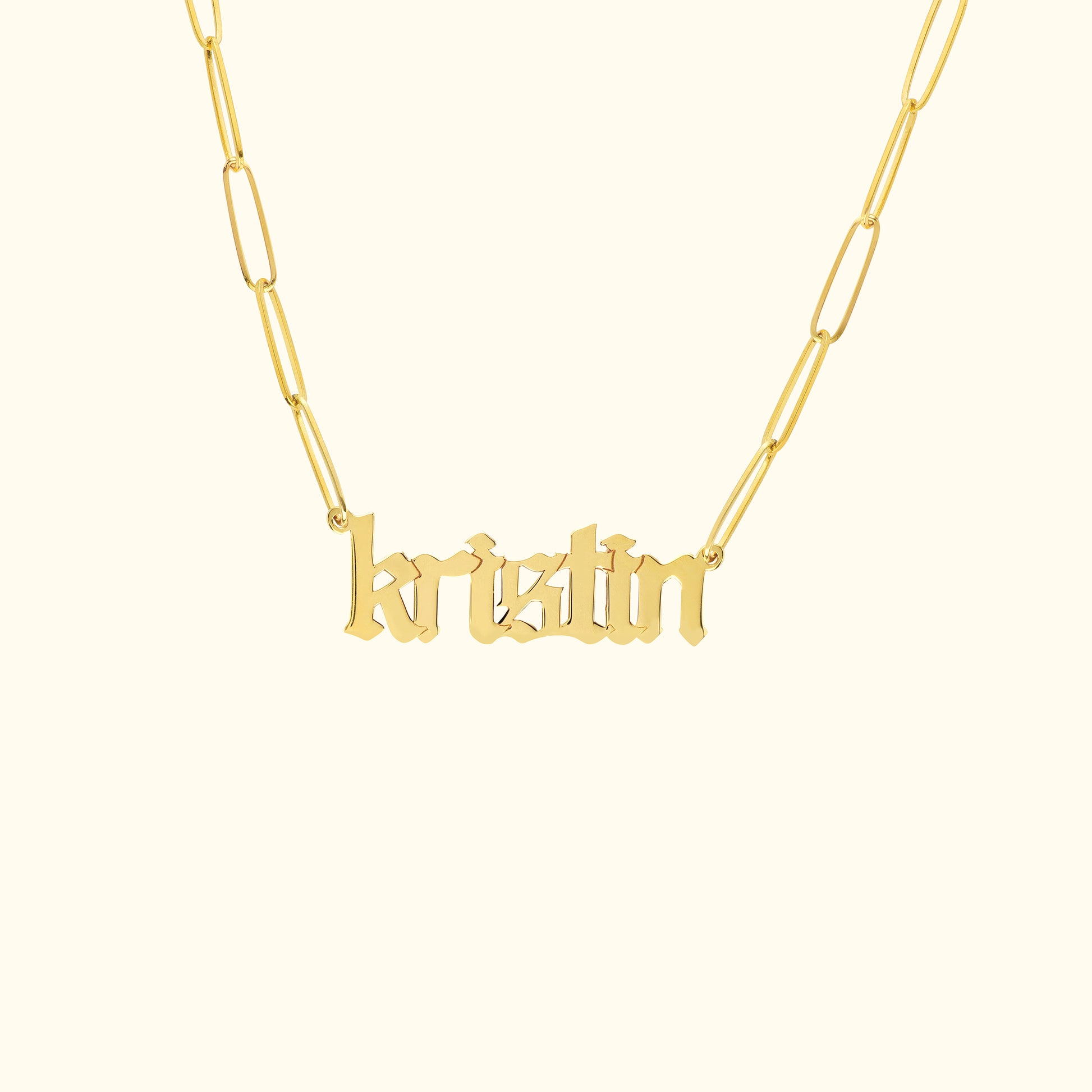 Gold name necklace displaying the name "kristin" in a stylish font.