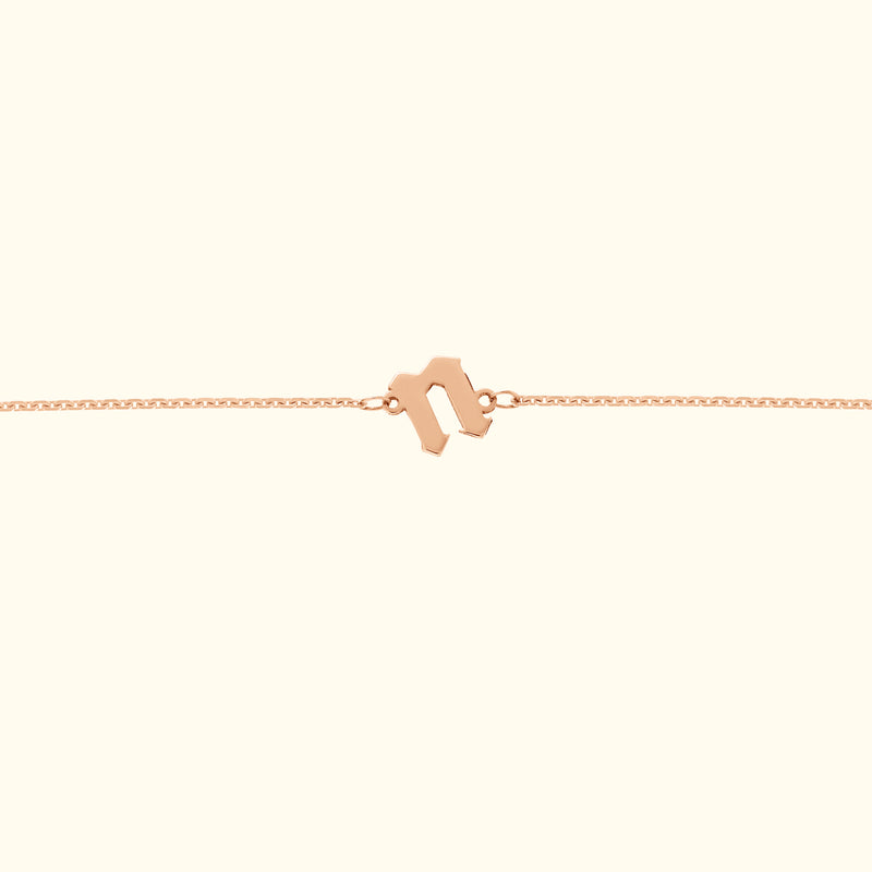 Delicate rose gold bracelet with a unique clasp design.