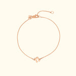 Delicate rose gold bracelet with a simple charm and adjustable clasp.