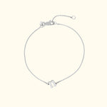 Delicate silver chain bracelet with a simple, stylish charm.