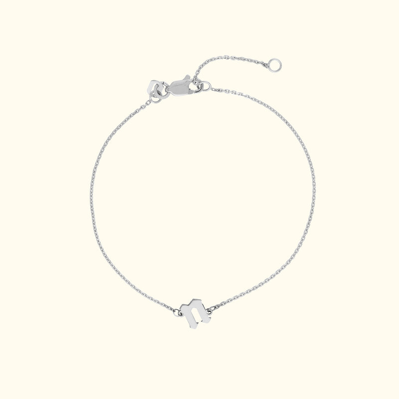 Delicate silver chain bracelet with a simple, stylish charm.