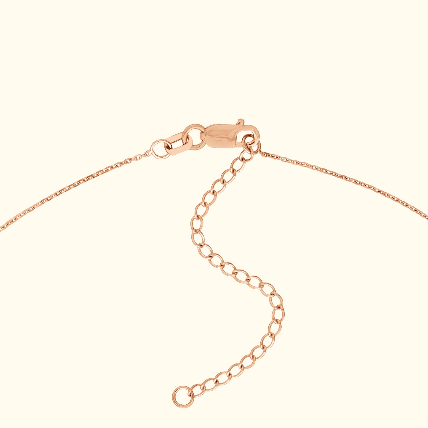 Close-up of a rose gold bracelet clasp with an adjustable chain extension.