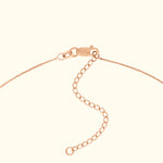 Close-up of a rose gold bracelet clasp with an adjustable chain extension.