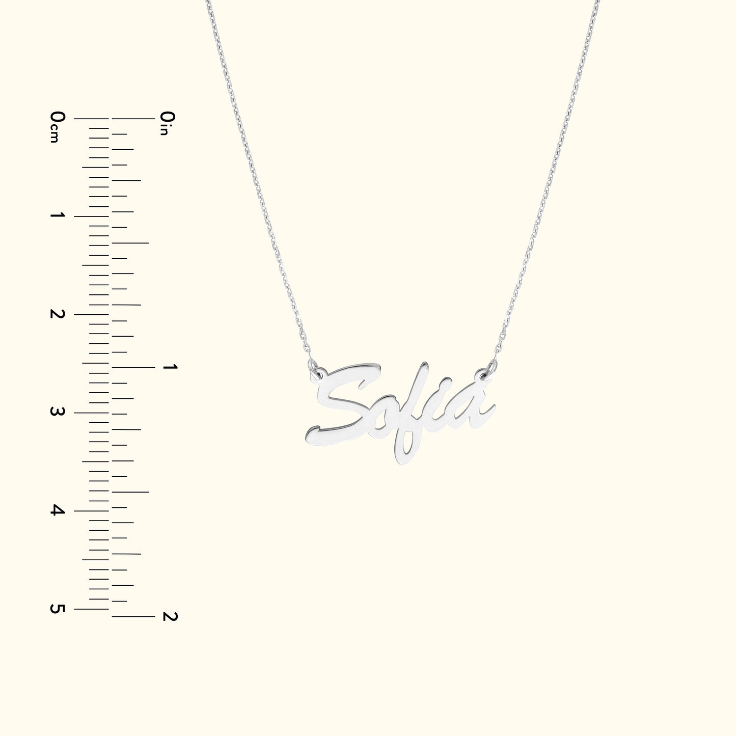 Silver necklace with the name "Sofia" in cursive lettering, displayed with a ruler for scale.