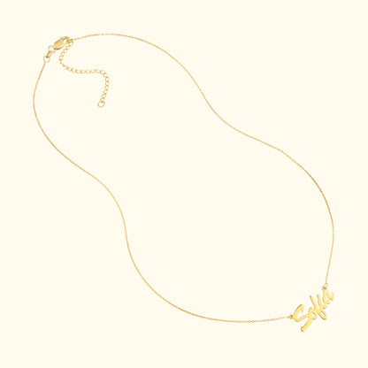 Gold necklace featuring a cursive name pendant that reads "Sofia."