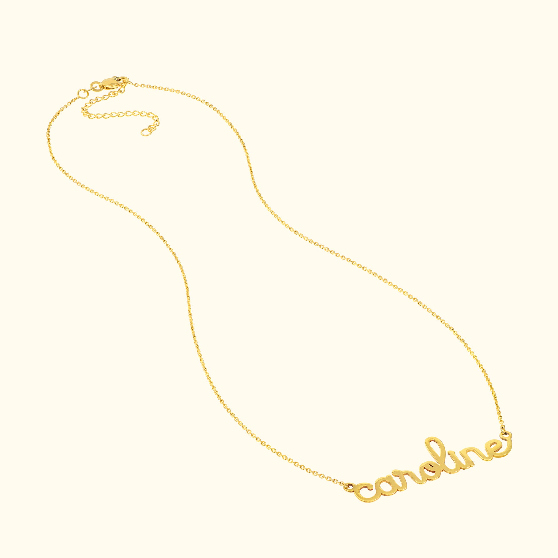 Gold necklace with the name "caroline" in cursive lettering.