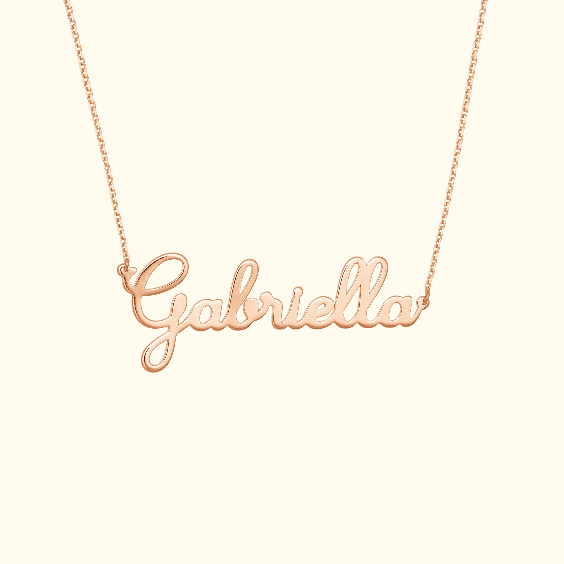 Rose gold name necklace spelling "Gabriella" on a delicate chain.