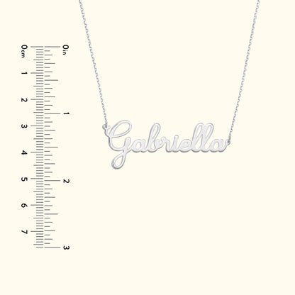 Silver name necklace spelling "Gabriella" with a ruler alongside for size reference.