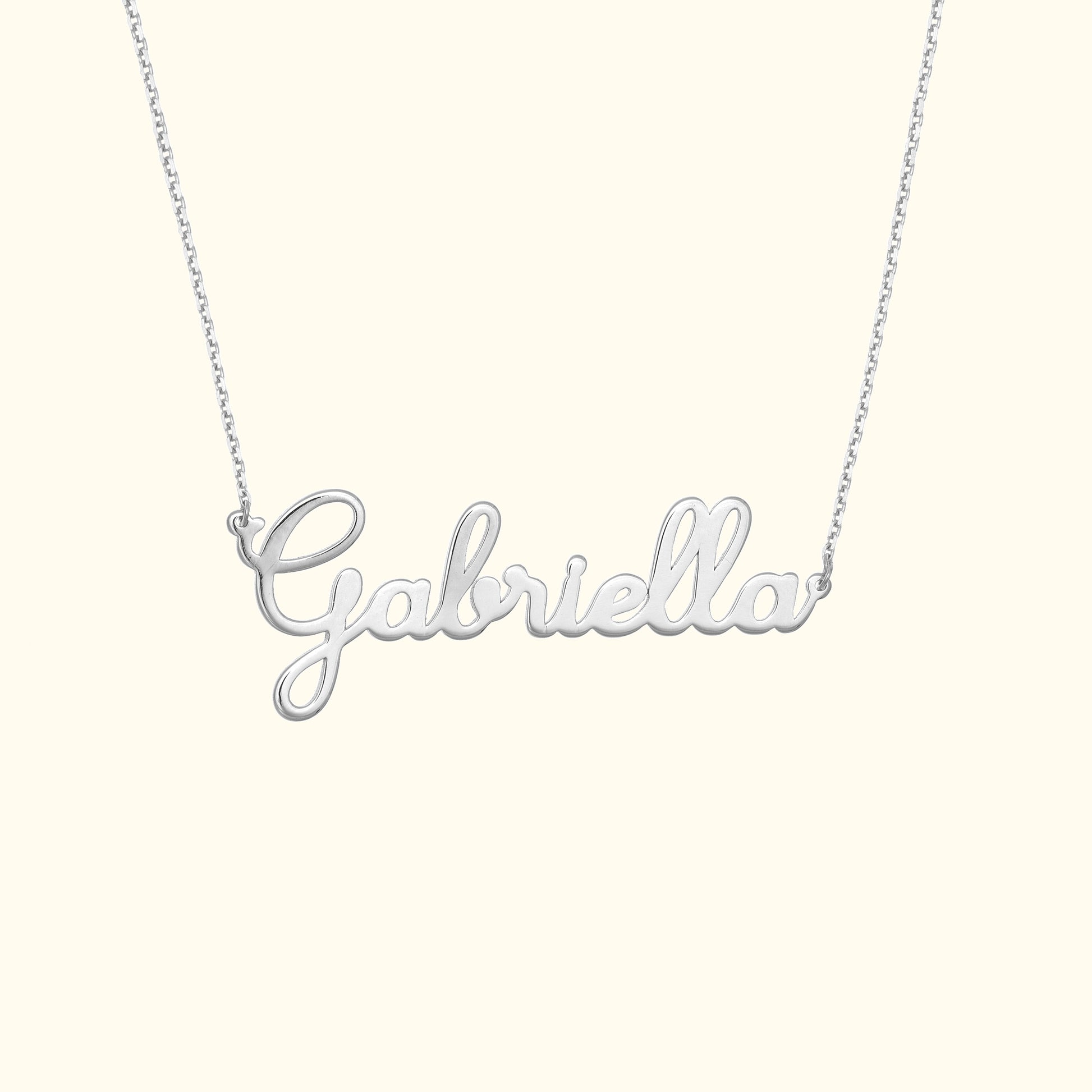 Silver name necklace with the script "Gabriella" on a delicate chain.