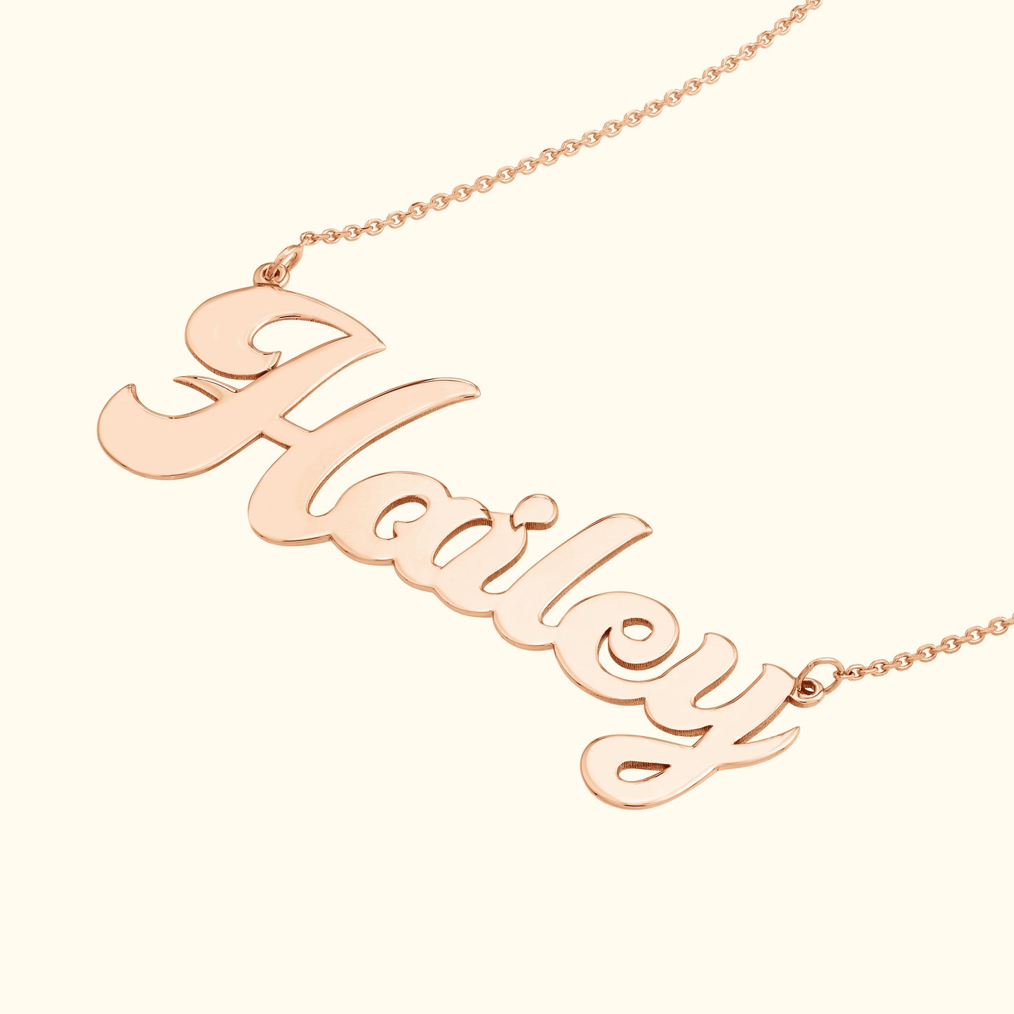 Rose gold name necklace with the script "Hailey."