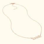 Rose gold necklace with a decorative cursive name pendant.