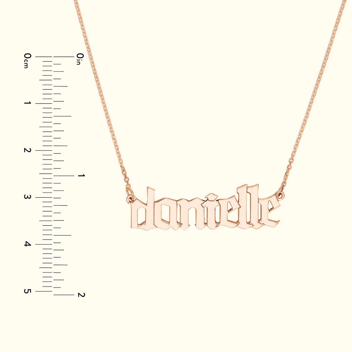 Personalized rose gold name necklace with the name "danielle" in stylized font.