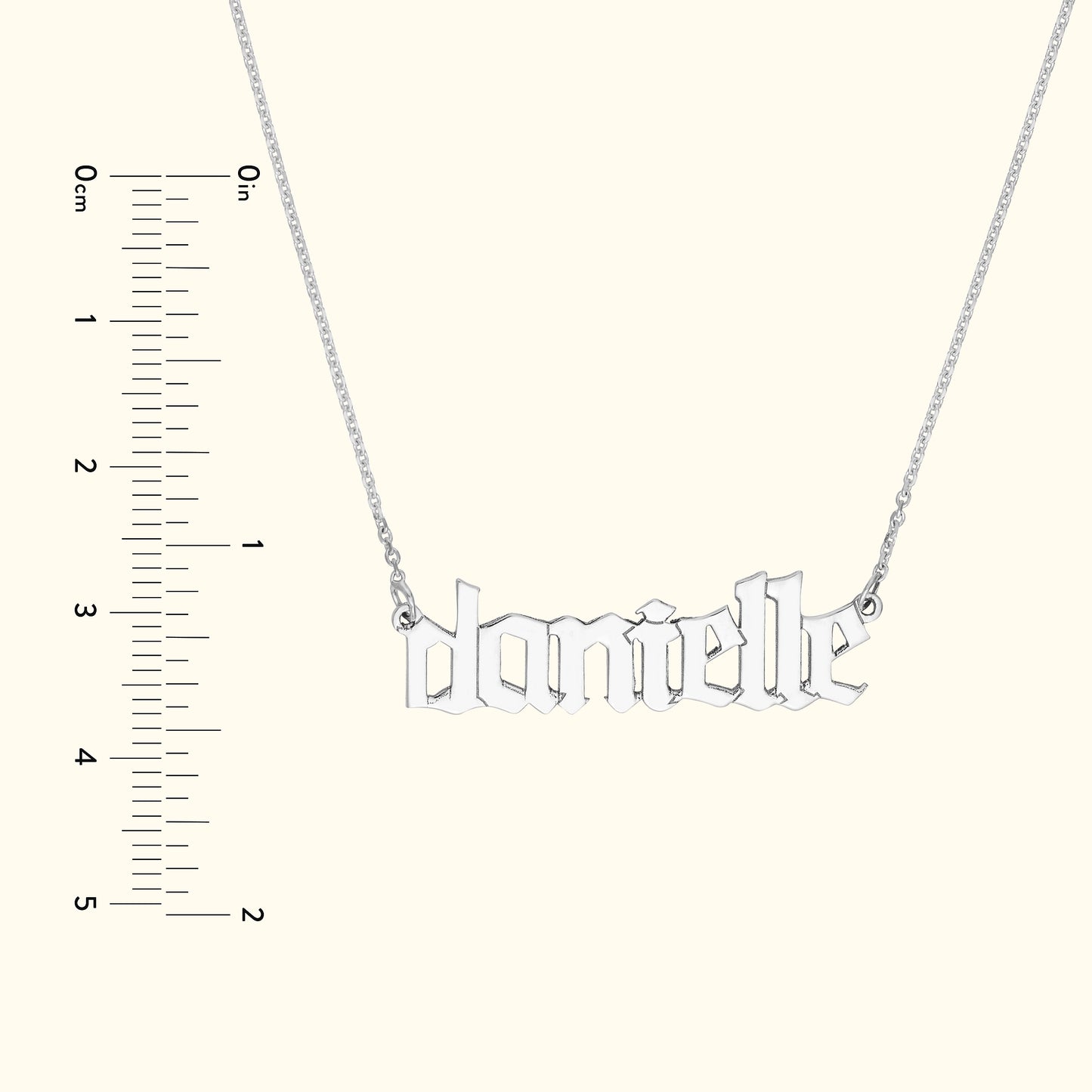 Silver necklace featuring the name "danielle" in a stylized font.