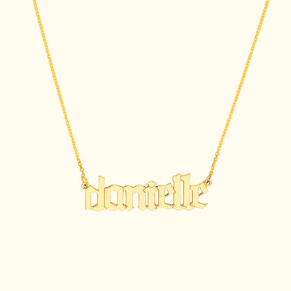 Gold name necklace featuring the name "danielle" in a stylized font.