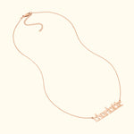 Rose gold chain necklace featuring the name "charlotte" in stylized lettering.