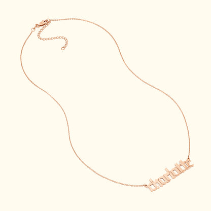 Rose gold chain necklace featuring the name "charlotte" in stylized lettering.