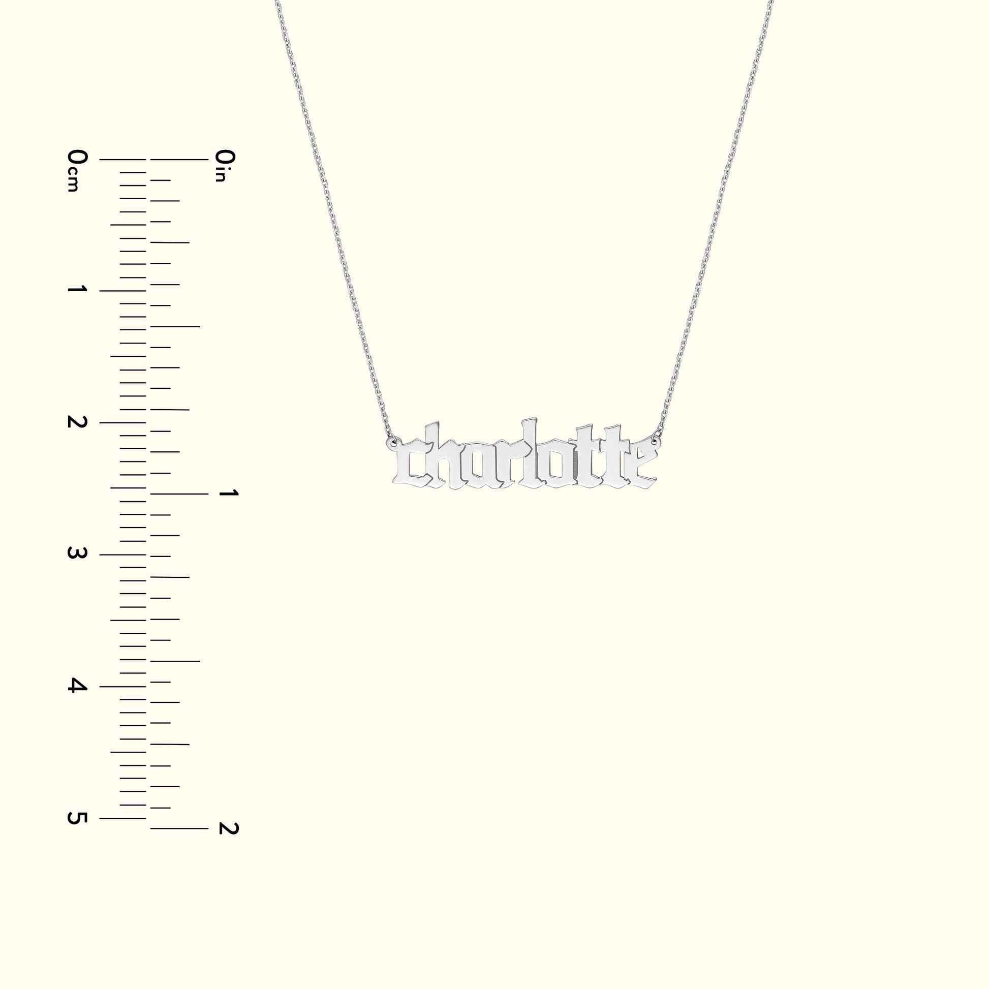 Silver necklace featuring the name "charlotte" in bold, stylized letters.