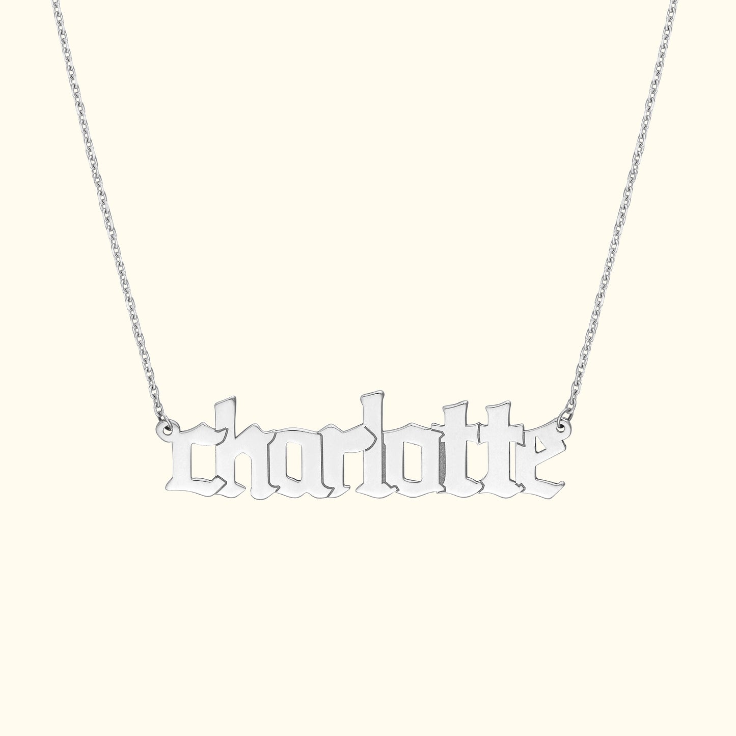 Silver necklace featuring the name "charlotte" in stylized script.