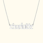 Silver necklace featuring the name "charlotte" in stylized script.