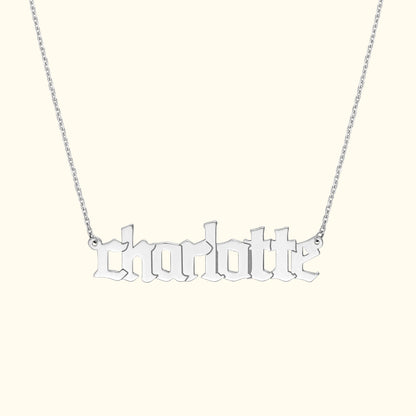 Silver necklace featuring the name "charlotte" in stylized script.