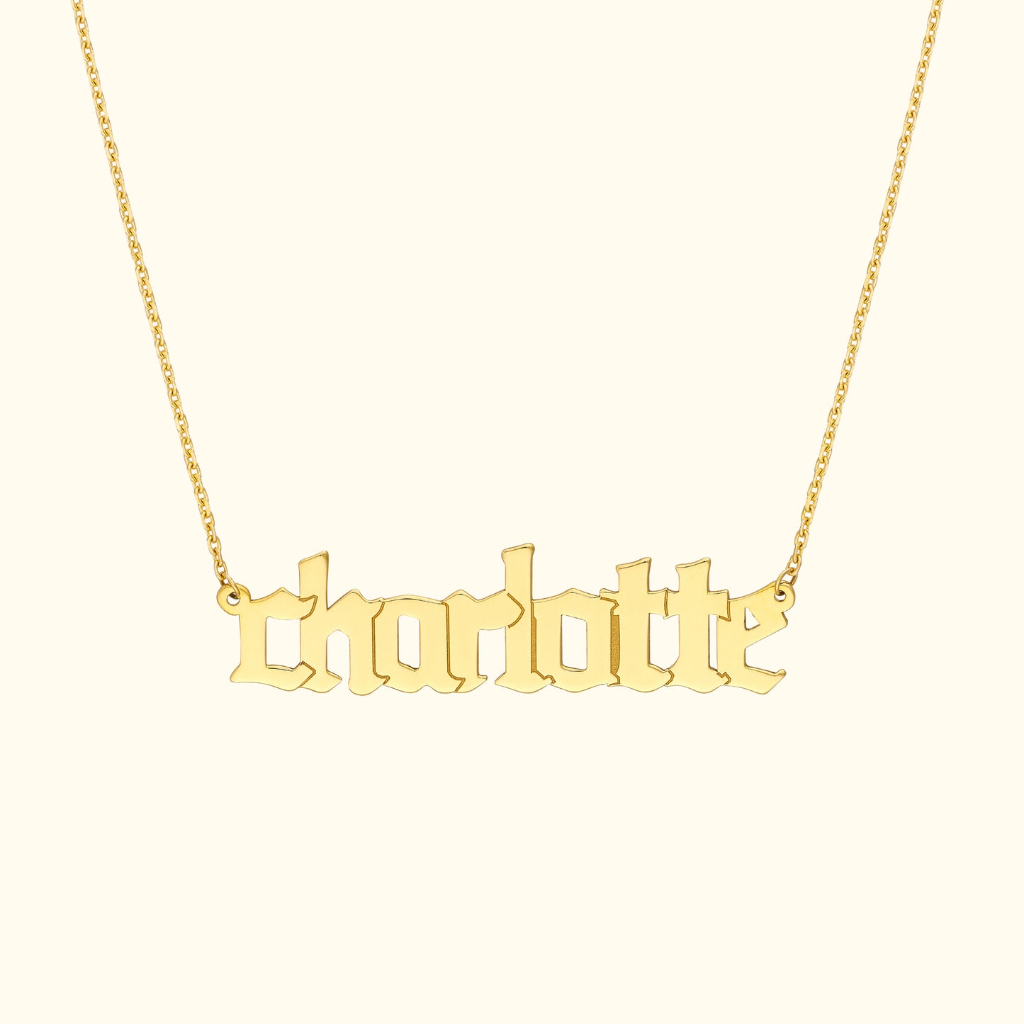 Gold name necklace with the word "charlotte" in an elegant font.