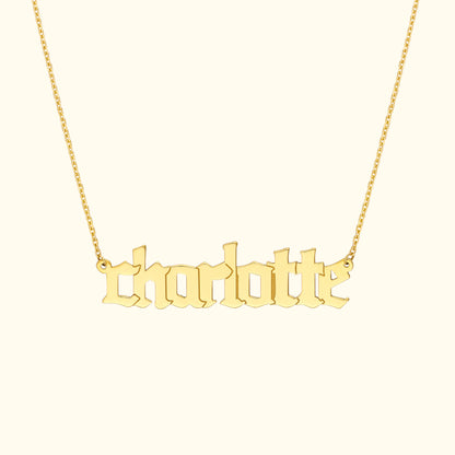 Gold name necklace with the word "charlotte" in an elegant font.