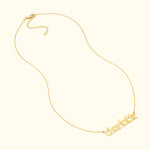 Gold name necklace with a delicate chain, featuring the name "Charlotte."