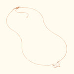 Delicate rose gold necklace featuring a playful outline charm.